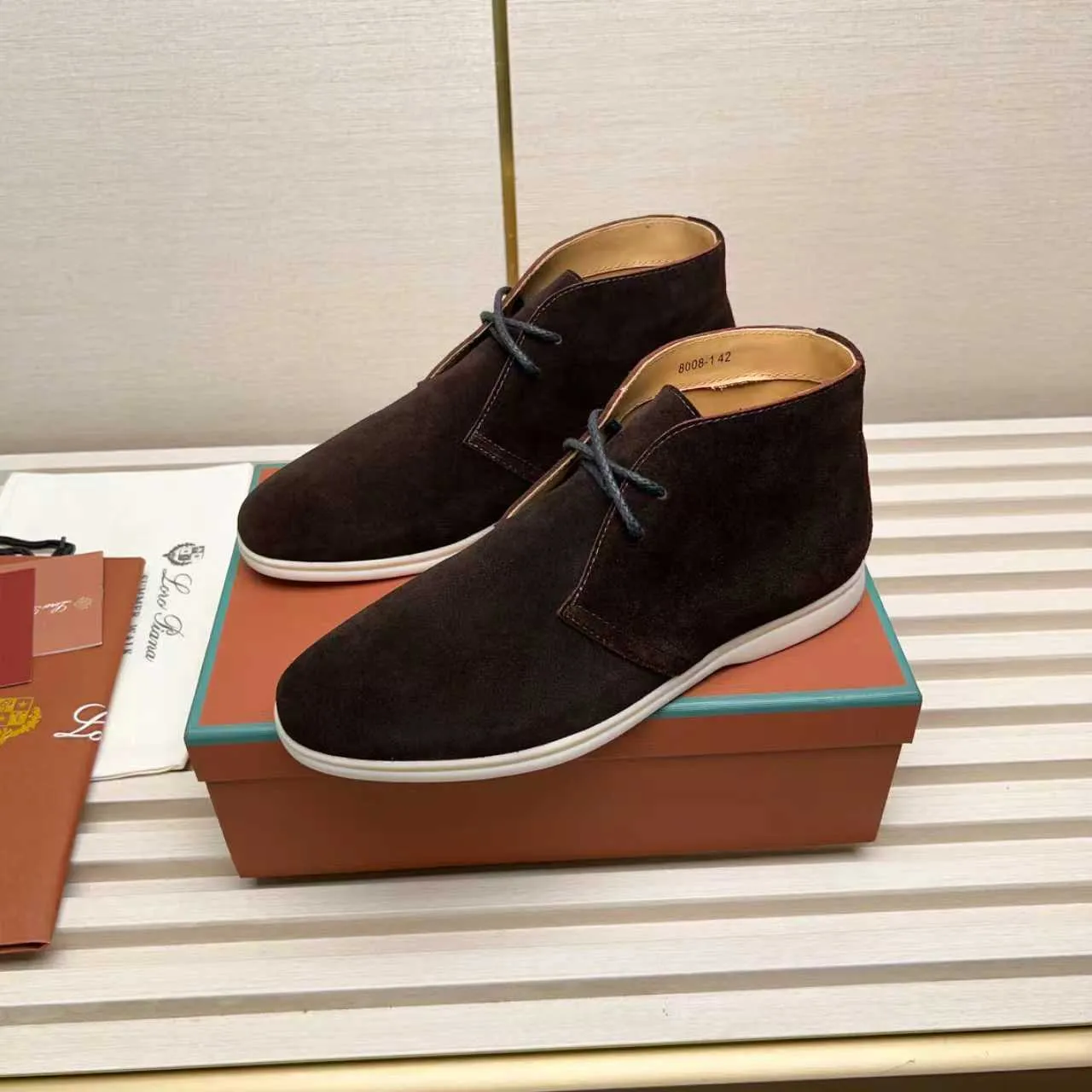 Men's Shoes 💰420 Loro Piana reimagines the desert boot—a modern, comfortable interpretation of a classic 1940s style. Crafted from suede calfskin, it exudes elegance. The tight texture of suede calfskin is not only durable but also looks casual and sophisticated. Add a timeless piece to your shoe collection, harmoniously blending comfort, style and Loro Piana's heritage of craftsmanship. Acetate satin detail on the inside White sole with LP lettering for added traction Space for a personalized signature on the heel Tonal suede trim Upper: 100% cow split suede Sole: 100% Rubber lining: Cow leather